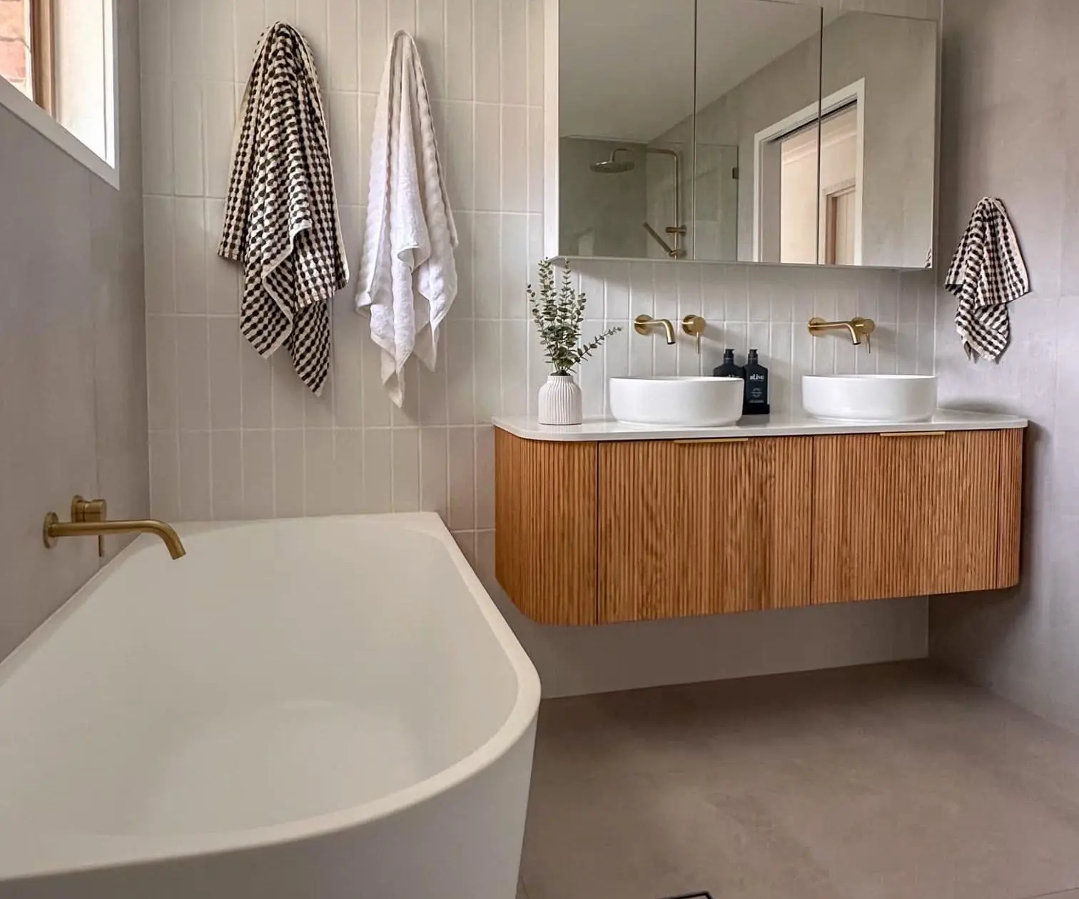 Renovated Gold Coast bathroom with freestanding bath and marble-look tiling by LB Plumbing Group